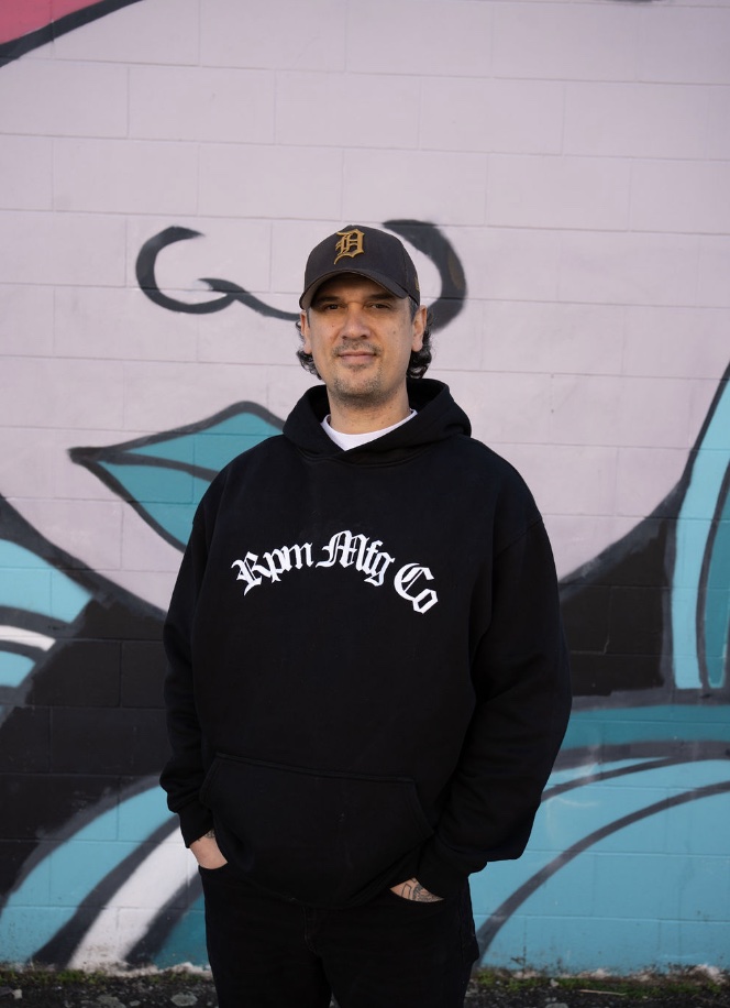 Cody Wharerau in front of a painted wall